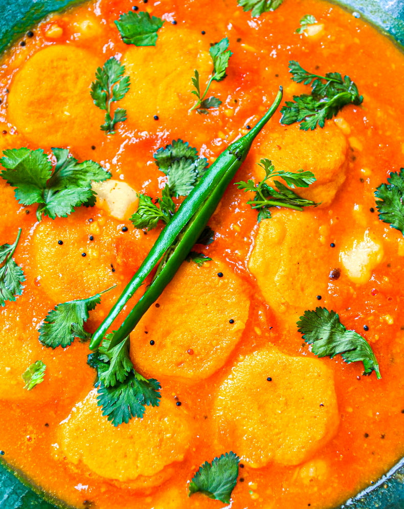 Bor'or Tenga (Tomato Medley Sour Curry with Red Lentil & Turmeric Fritters)