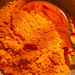 Glass jar filled with golden Lakadong turmeric powder