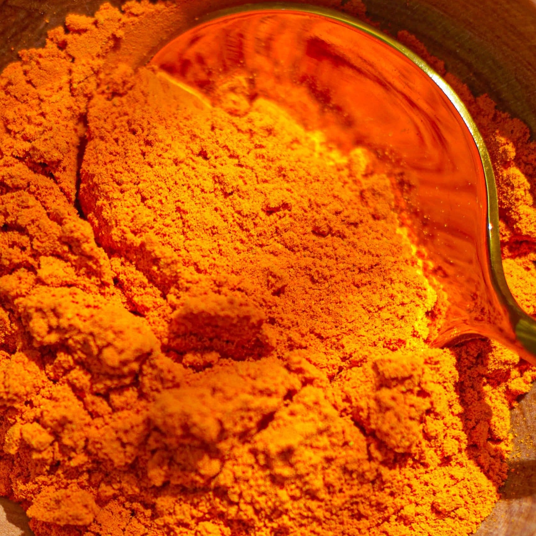 Glass jar filled with golden Lakadong turmeric powder